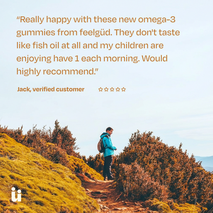 Person hiking on a trail with a scenic background, featuring a customer review about omega-3 gummies.